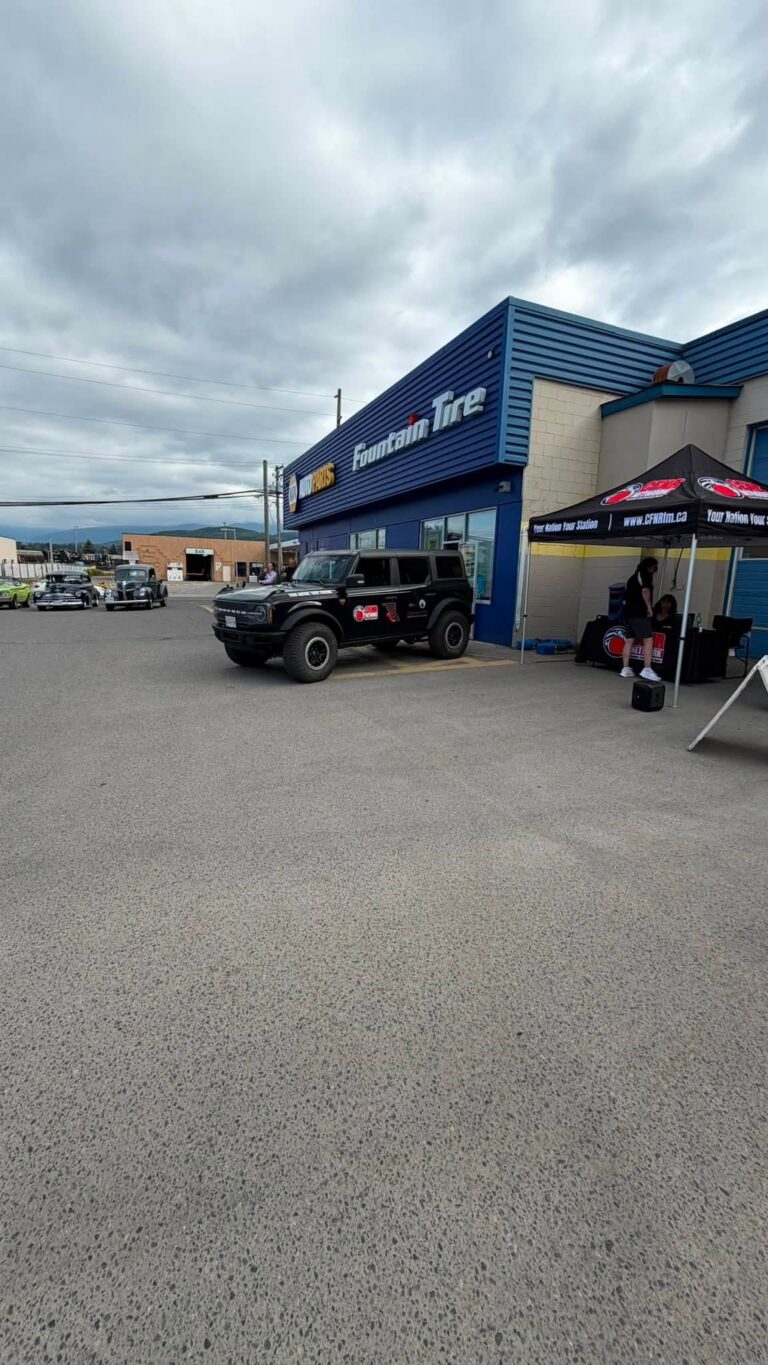 Fountain Tire Terrace store with tents and a vehicle outside.