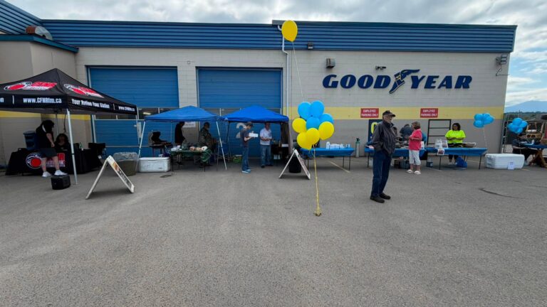 BBQ and information tables set up outside the Goodyear service bays.