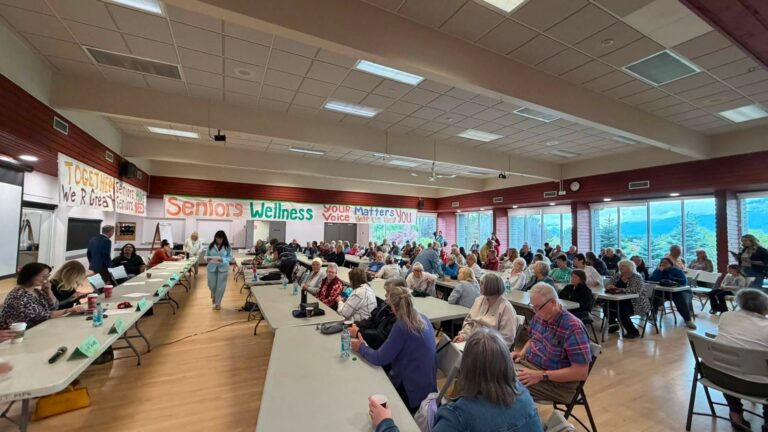Wide view of the banquet room filled with attendees.